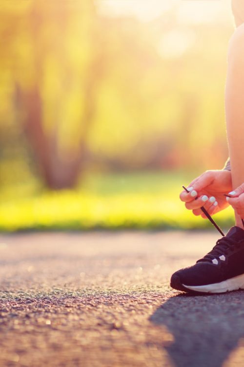 Young woman running in the park. Active person outdoors at the dusk in summer