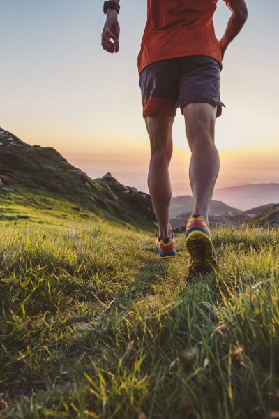 Man trail running on a mountain at the dask