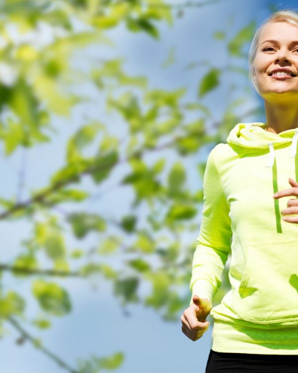 fitness, people and healthy lifestyle concept - happy young female runner jogging outdoors